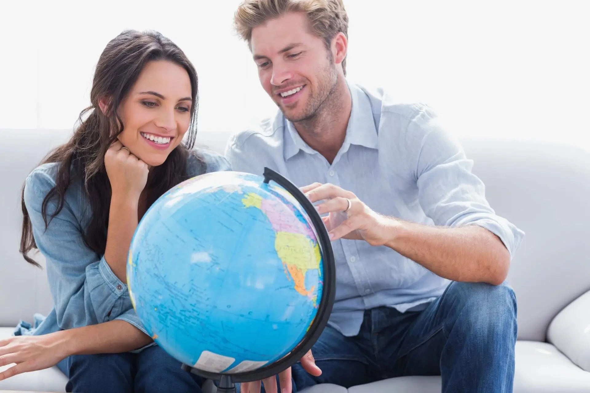 A man and woman holding an earth globe.